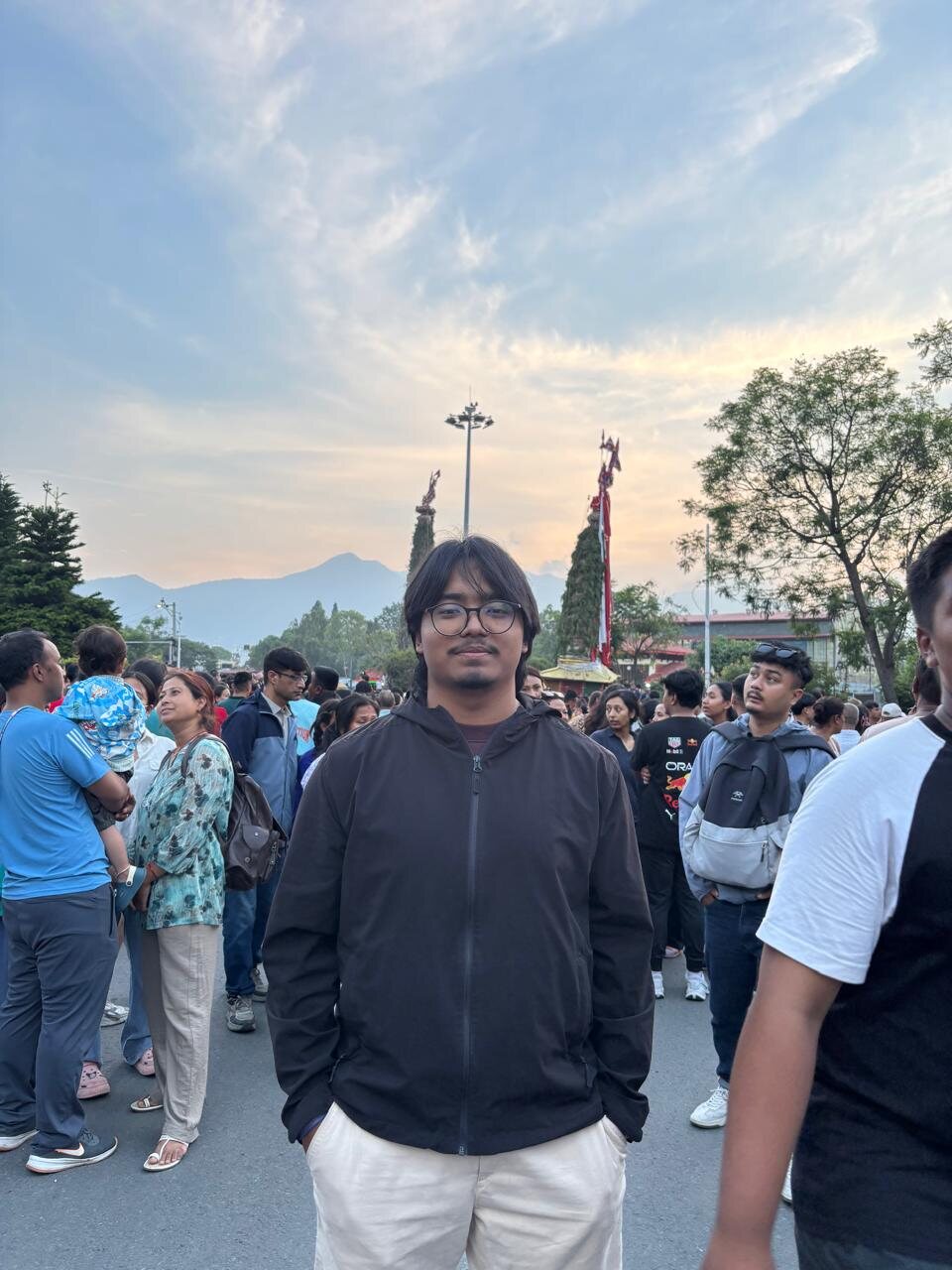 Abhishek Pradhan, standing in a Kathmandu street during the festival